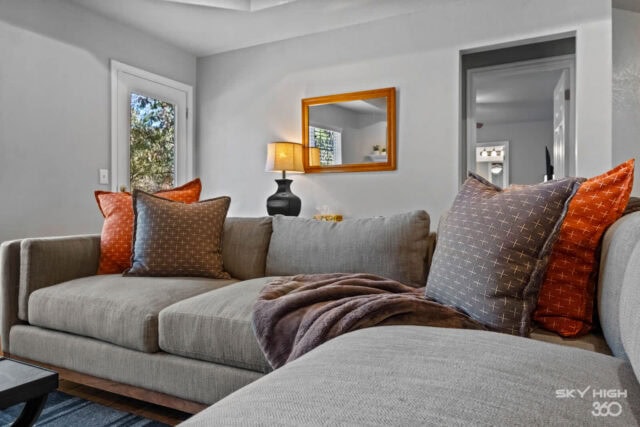 Cozy living room with neutral tones and colorful accent pillows in a rustic retreat near Ozark mount.