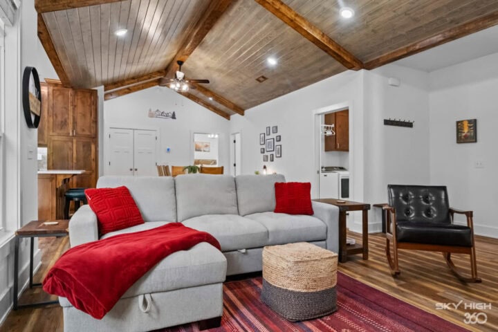 Cozy living room in Black Bear Cabin with vaulted wooden ceiling and modern decor.