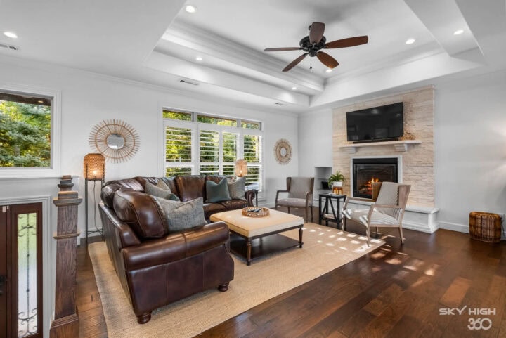 Cozy living room with fireplace and large windows at Rivercliff Ridgehouse, Beaver Lake view vacatio.