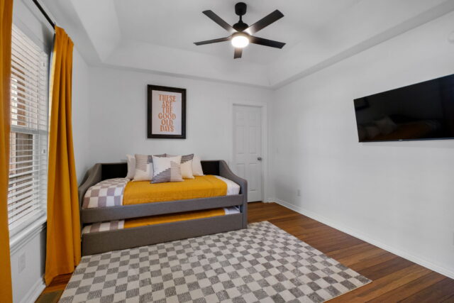 Cozy bedroom in Bella Vista vacation rental near Back 40 Trails with modern decor and comfortable fu.