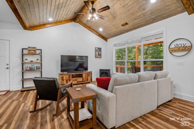 Relaxing living room with modern decor, large windows, and cozy seating in Black Bear Cabin, Bella V.