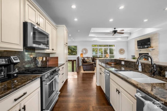 Modern kitchen with granite countertops and white cabinetry at Rivercliff Ridgehouse, Beaver Lake vi.