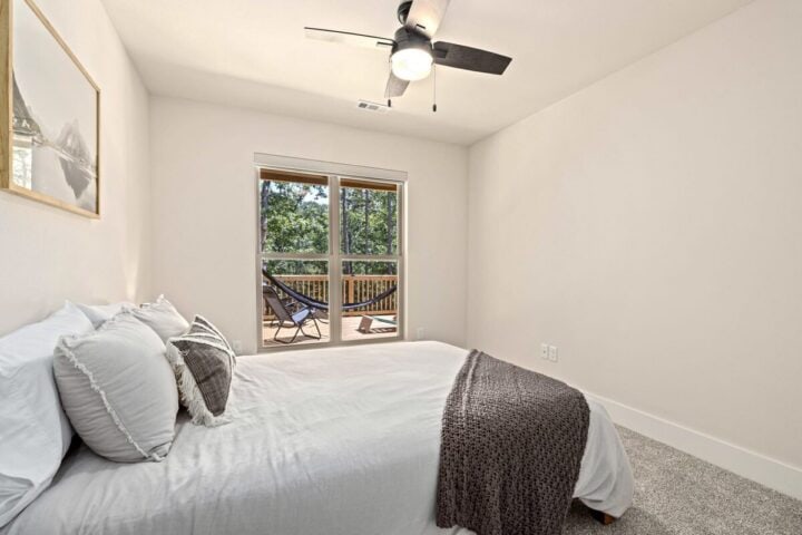 A comfortable bedroom in a vacation rental near Back 40 Trails, featuring modern decor and access to.