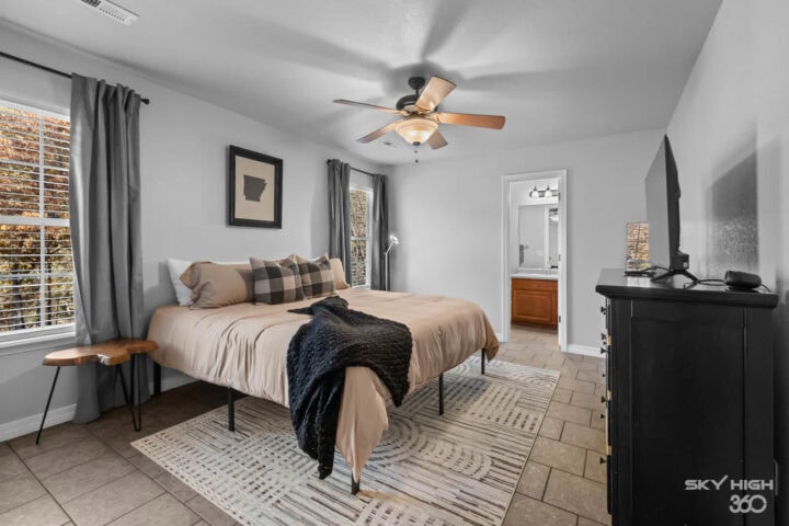Cozy bedroom with large windows, neutral decor, and modern furnishings in a peaceful retreat near Oz.