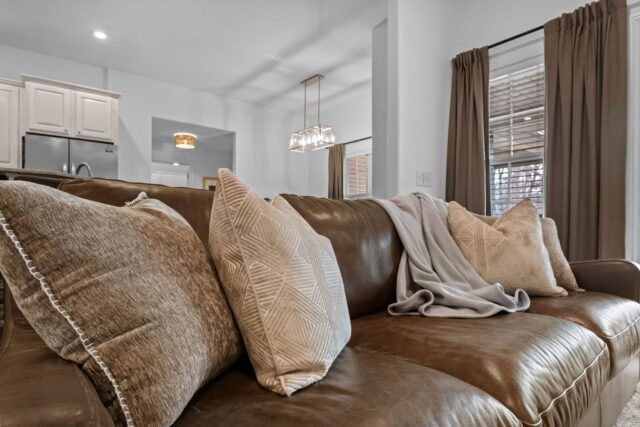 Relaxing living room with cozy sofa and natural light at The Witherby Woodland Retreat, Bella Vista.