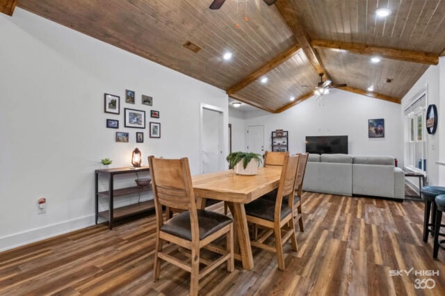 Cozy living and dining area inside Black Bear Cabin with rustic wooden ceiling and modern furnishing.