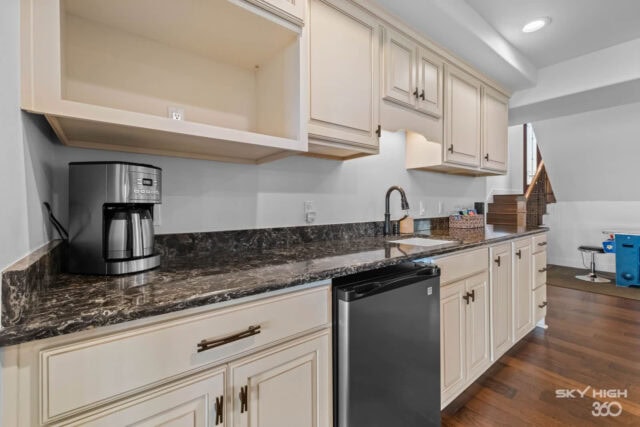Modern kitchen with white cabinets, granite countertops, and stainless steel appliances in Riverclif.