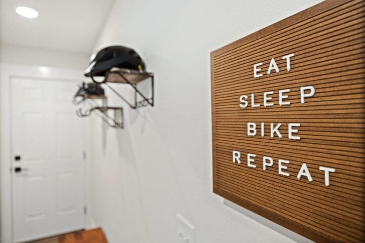 Modern interior with bike helmet storage and motivational "Eat Sleep Bike Repeat" sign in Oz Adventu.