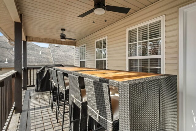 Elegant outdoor covered patio with dining table and ceiling fans at The Witherby Woodland Retreat.
