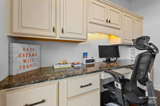 Having a workspace in a cozy kitchen area with cabinets and a computer for remote work.