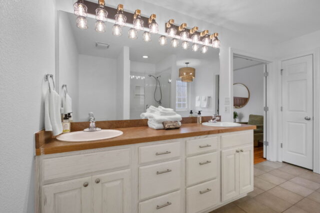 Modern bathroom with double sink and bright lighting at Bella Vista Vacation Rental.