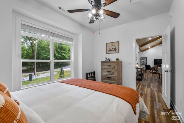 Cozy bedroom in Black Bear Cabin with large window overlooking lush greenery, perfect for relaxing b.