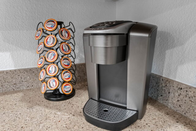 Fresh coffee station with Keurig machine and coffee pods at The Witherby Woodland Retreat. Perfect f.