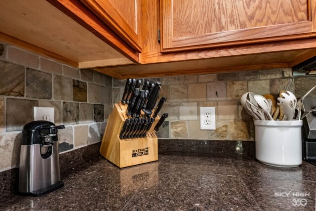 Modern kitchen countertop with knife block, coffee maker, and utensil holder in a cozy vacation rent.