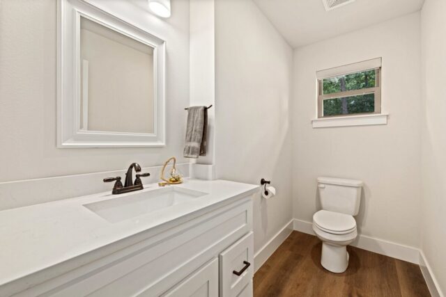 Modern bathroom with white vanity and toilet at OZ Adventure Retreat near Back 40 Trails.
