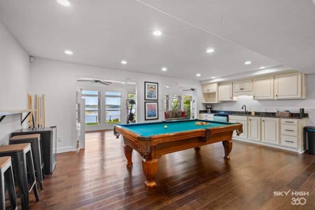 Spacious game room with pool table and lake views at Rivercliff Ridgehouse vacation rental in Rogers.