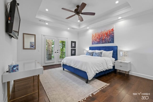 Relaxing bedroom with blue accent headboard, modern decor, and river view in Rogers, AR vacation ren.