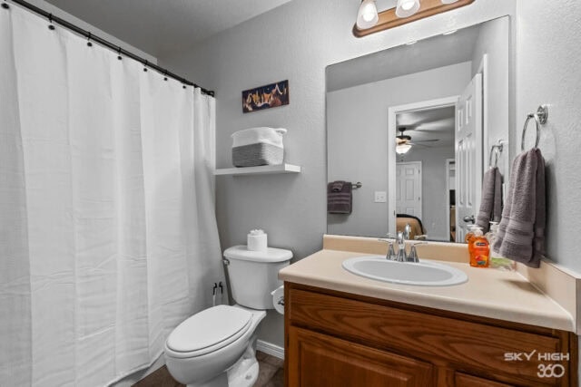 A comfortable bathroom with a white shower curtain, wooden vanity, and modern fixtures in a cozy vac.