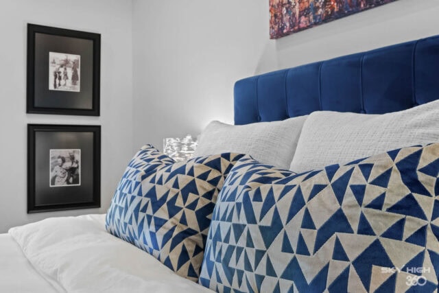 A comfortable bed with geometric patterned pillows in a modern bedroom at Rivercliff Ridgehouse, a B.