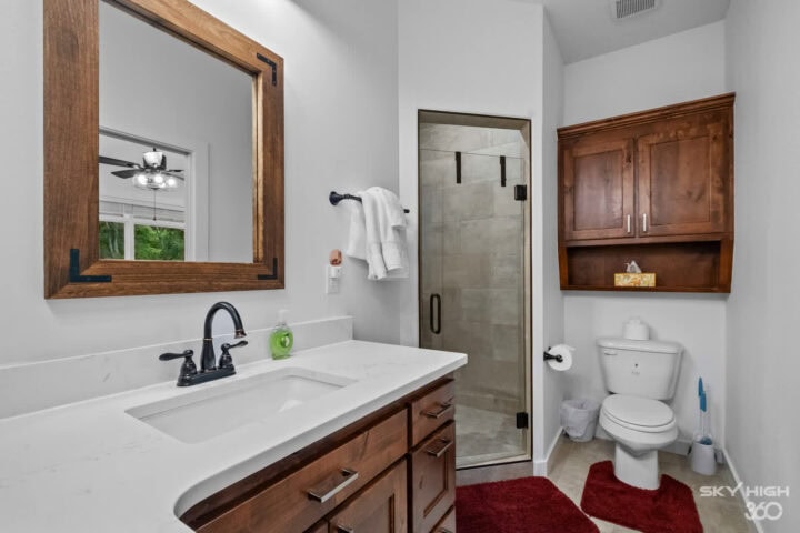 Modern bathroom in Black Bear Cabin with walk-in shower and wooden accents.