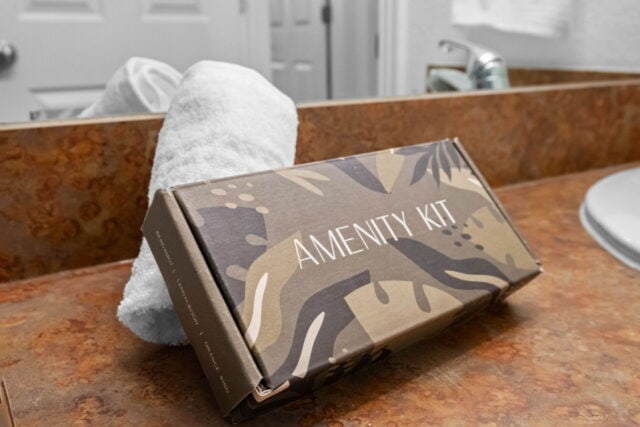 Amenity kit on bathroom counter at The Witherby Woodland Retreat vacation rental.