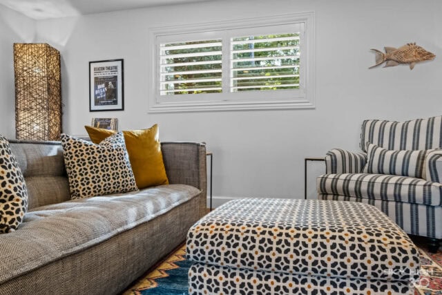 A comfortable living room with patterned sofas and decorative pillows in a vacation rental home.