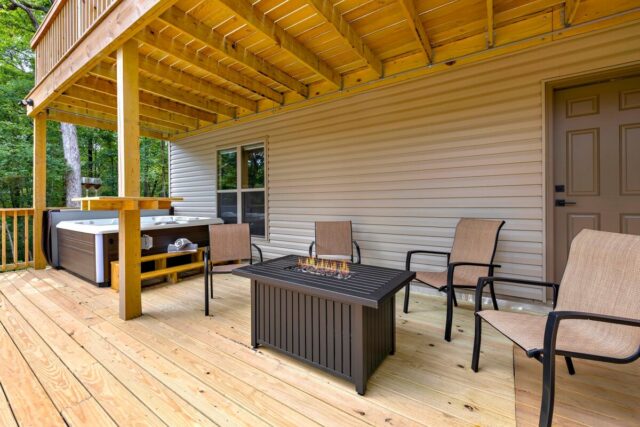 Relaxing outdoor deck with seating and hot tub at Bella Vista vacation rental near Back 40 Trails.