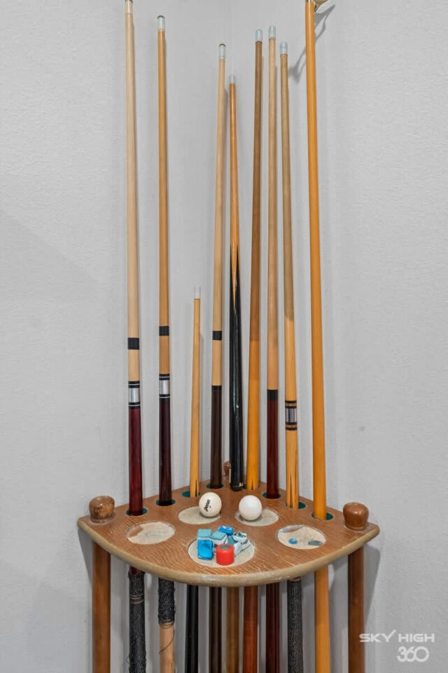 Golf clubs and accessories arranged on a small table against a white wall at Rivercliff Ridgehouse,.