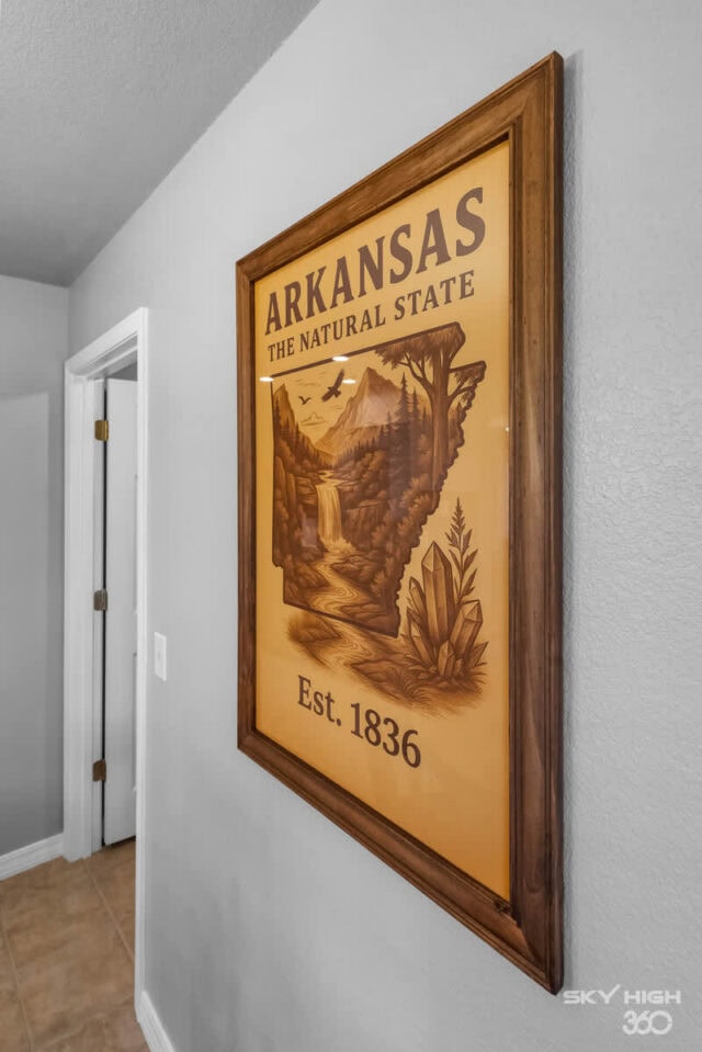 Arkansas state map and natural scenery poster in a cozy home interior.