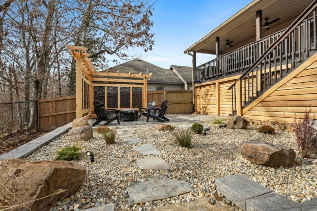 Cozy backyard with fire pit, seating area, and landscaped garden near Bella Vista vacation rental.