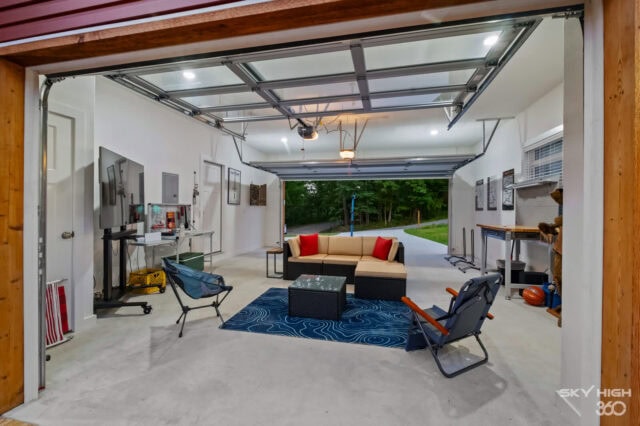 Black Bear Cabin garage with seating area, bikes, and outdoor views in Bella Vista.