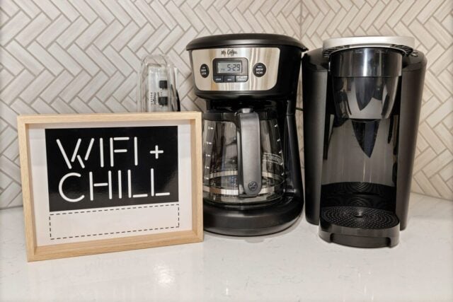 Coffee maker and "WiFi + Chill" sign in a modern kitchen setting.