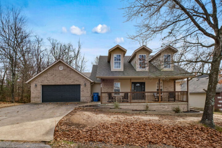 Modern house with garage and front porch near Back 40 Trails in Bella Vista.