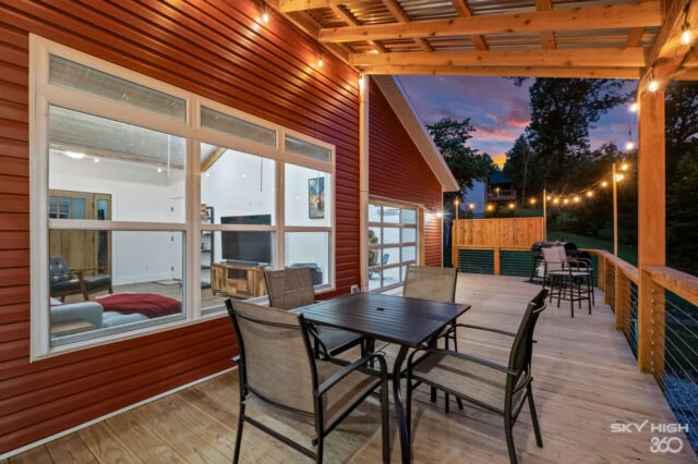 Cozy outdoor deck at Black Bear Cabin with seating and string lights, perfect for relaxing after bik.