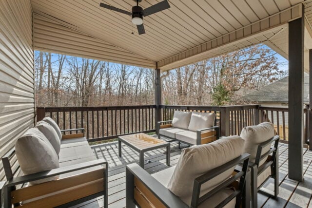 Cozy outdoor porch with seating overlooking wooded landscape near Back 40 Trails.
