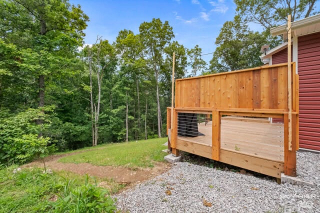 Wooden deck with railing at Black Bear Cabin, bike-in vacation rental in Bella Vista.