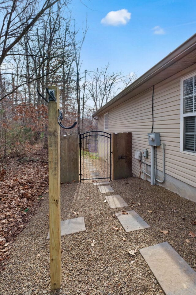 Cozy backyard pathway with gate at The Witherby Woodland Retreat near Back 40 Trails.