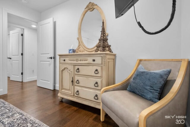 Elegant bedroom decor with vintage dresser and cozy armchair in a Rivercliff Ridgehouse vacation ren.