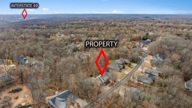 A lush wooded property near Back 40 Trails with nearby Interstate 49.