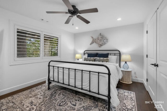 Cozy bedroom with white walls, black metal bed frame, and lake view in Rogers, AR.