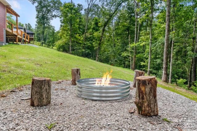 Cozy outdoor fire pit with log seats at Black Bear Cabin in Bella Vista, perfect for relaxing after.