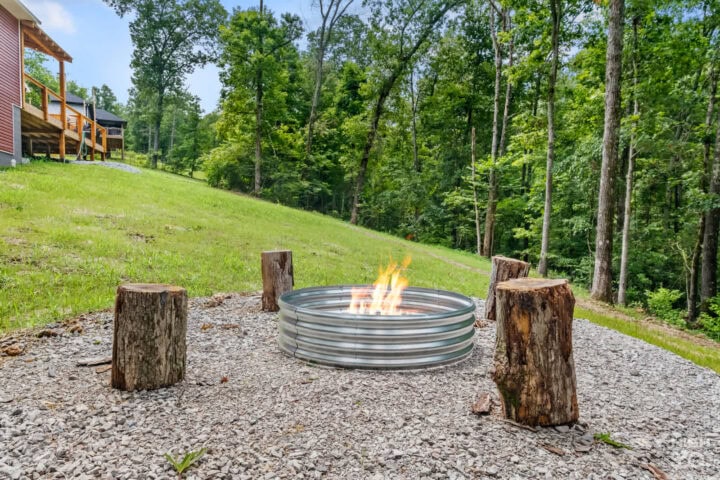 Cozy outdoor fire pit with log seats at Black Bear Cabin in Bella Vista, perfect for relaxing after.