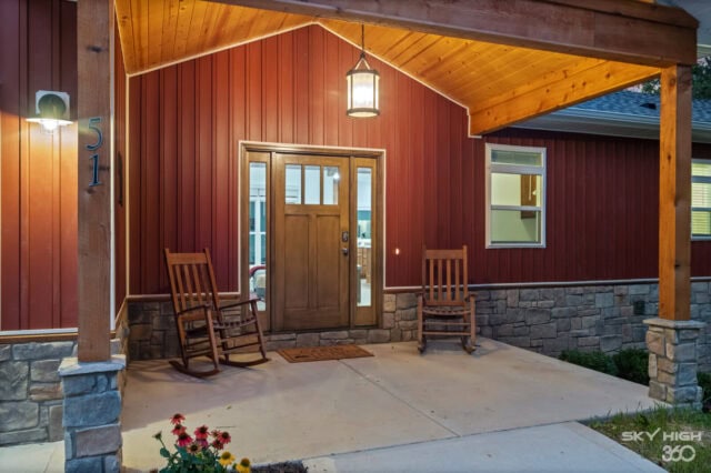 Cozy front porch of Black Bear Cabin with rocking chairs in Bella Vista, Arkansas.