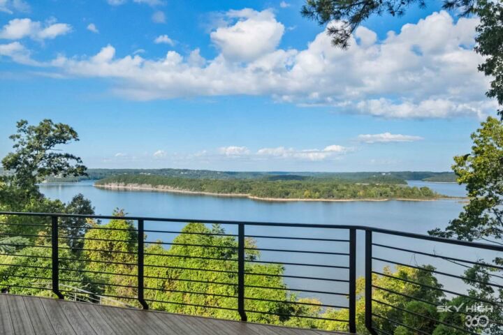A lush view of Beaver Lake from the Rivercliff Ridgehouse balcony in Rogers, AR. Perfect for vacatio.
