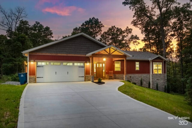 Modern red cabin with garage in wooded setting near Bella Vista, Arkansas.