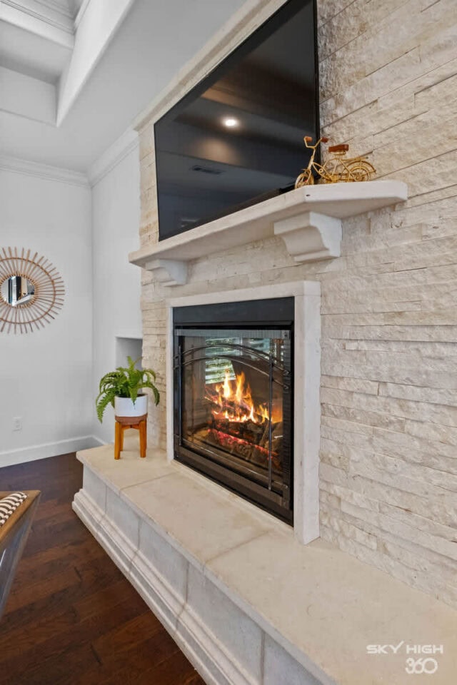 A comfortable living room fireplace with a mounted TV and modern decor in a vacation rental.