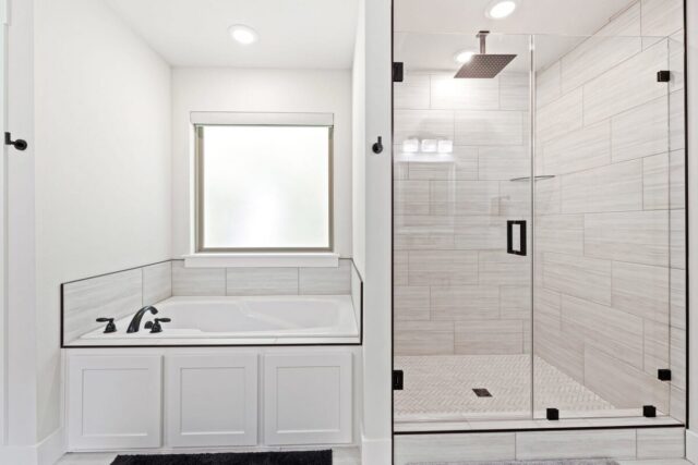 Relaxing modern bathroom with bathtub and walk-in shower at OZ Adventure Retreat near Back 40 Trails.