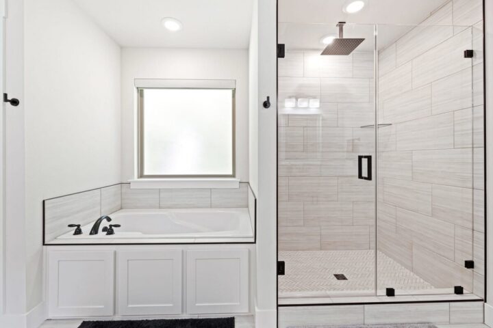 Relaxing modern bathroom with bathtub and walk-in shower at OZ Adventure Retreat near Back 40 Trails.