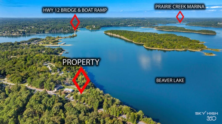 Scenic aerial view of Beaver Lake with property, Prairie Creek Marina, and HWY 12 Bridge & Boat Ramp.