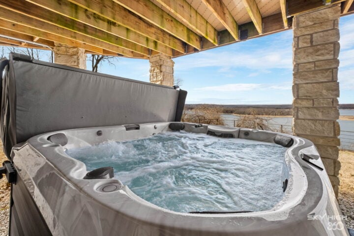 Hot tub overlooking Beaver Lake in Rogers, AR, perfect for relaxing vacation rentals.